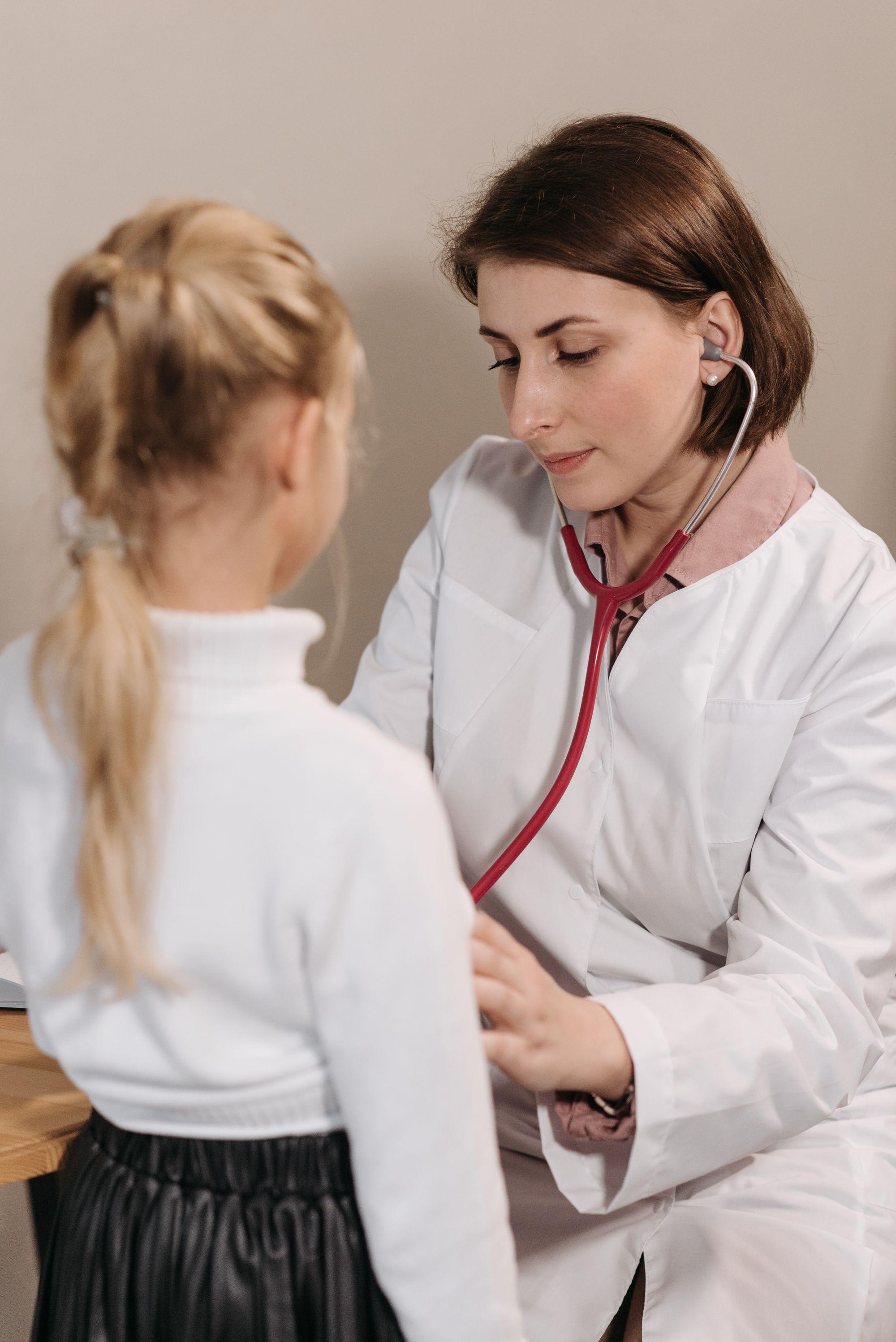 A doctor examining a young girl in a clinic