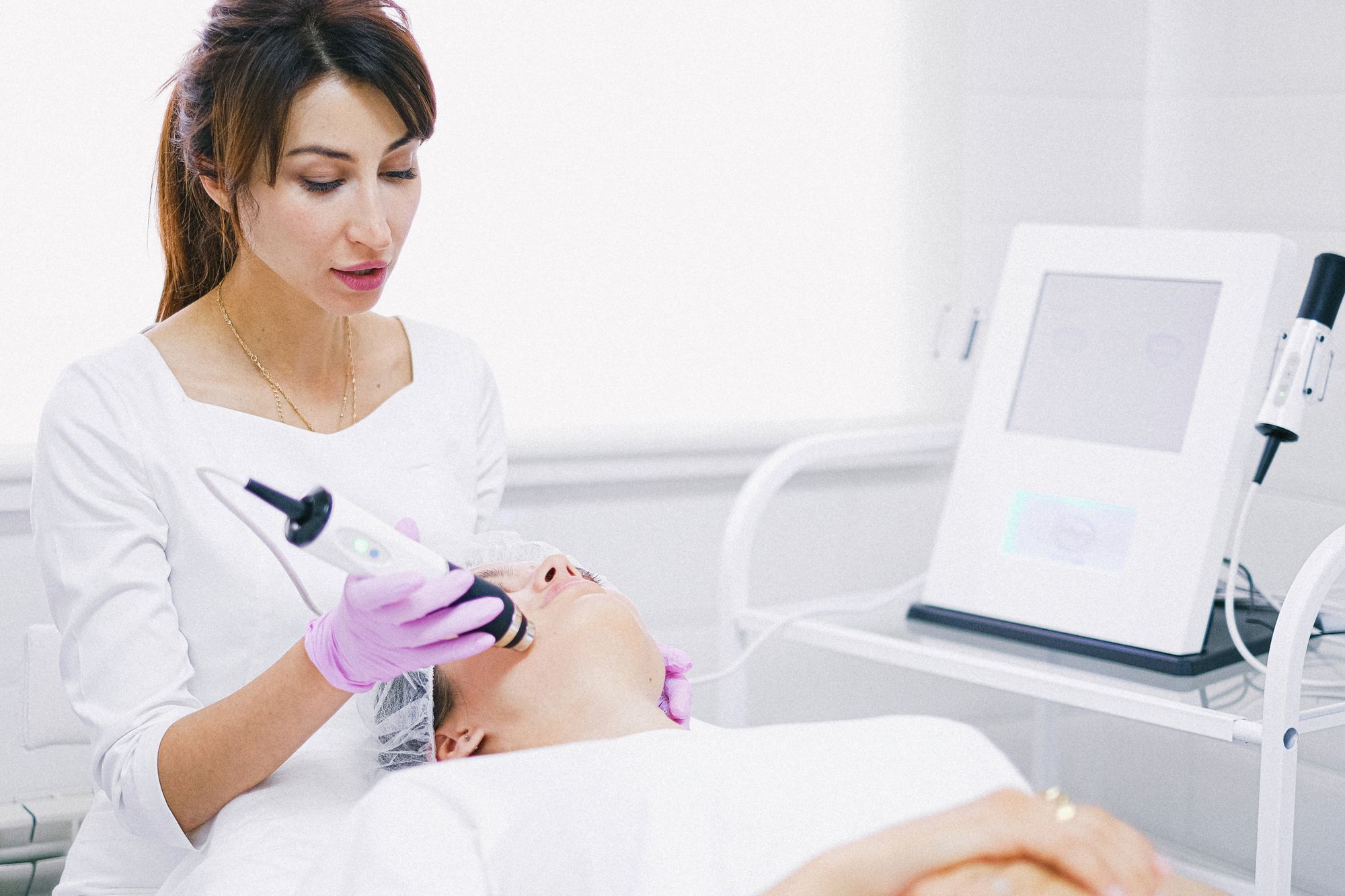 A clinician preparing a laser treatment beside the device