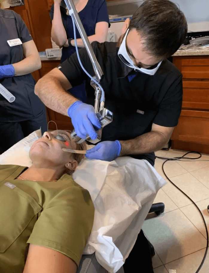 One of the practice's providers performing a laser treatment